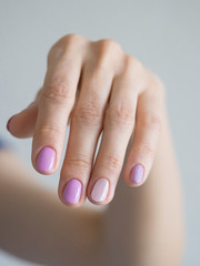 A woman's hand with a pastel manicure, close-up