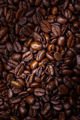 Close up to a heap of coffee beans.
Macro photography of fresh roasted coffee beans high resolution. Detailed macro picture on roasted coffee beans.  Close-up of brown coffee beans background  image