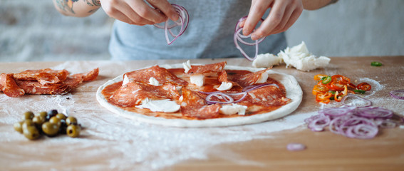 Original italian pizza preparation with hands panoramic