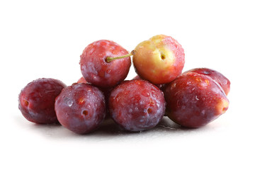 Red plums isolated on white