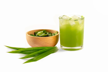 Close up Fresh pandan juice in glass with sliced in wooden bowl and leaves isolated on white background.