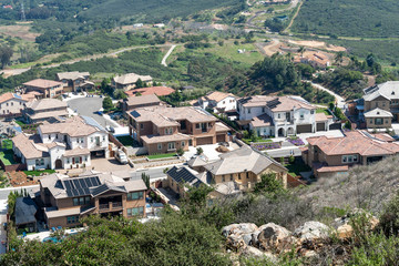 Fototapeta na wymiar Aerial view of upper middle class neighborhood with big villas around Double Peak Park in San Marcos, California, USA.