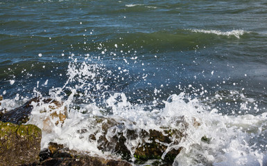 Waves breaking onto a stony seashore.
