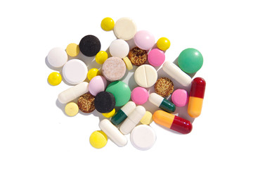 A pile of colorful pills on a white background with shadow.