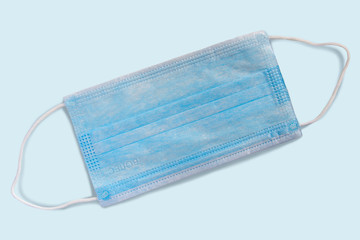 Medical mask with shadow isolated on a blue background.