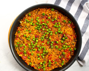 Vegan Paella with red peppers and green beans. 