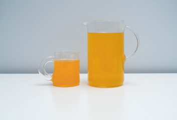 A glass of orange juice on the white table. A healthy and delicious orange juice.