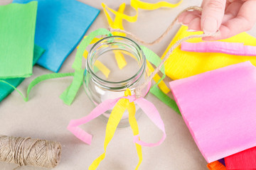 Woman shows how to transform a standard glass jar into a beautiful hanging candle holder