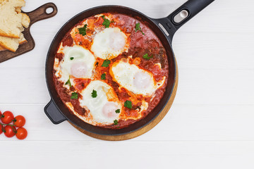 Delicious egg and tomatoo dish Shakshuka in iron skillet
