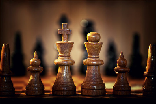Close-up Of Wooden Chess Pieces On Board