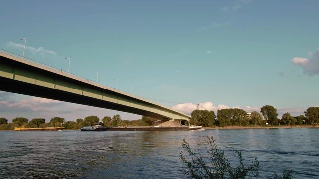 K&ouml;ln Zoobr&uuml;cke with Cargo Ship in sunny afternoon - Cologne, Germany Establisher 4K + Atmo