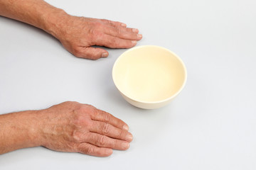 Hungry man waiting for his meal over empty bowl.