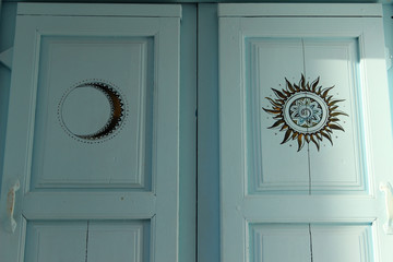 Door with drawings of a sun and a moon