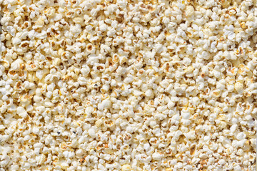 Large group of fresh cooked popcorn displayed for sale at a street food market, photographed with soft focus in warm yellow light, top view photo of healthy food photographed with soft focus
