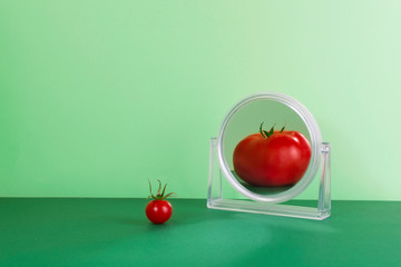 Tomato in mirror reflection.  The reality is different than the image