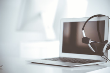 Call center and communication support, customer service help desk. VOIP headset on laptop computer