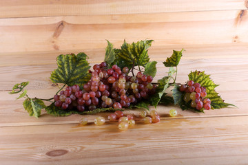 Grape and leaves on table