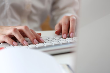 Female hands typing on silver keyboard using computer pc at workplace closeup. White collar job, digital shopping, office lifestyle, search success, enter login, password and credentials concept
