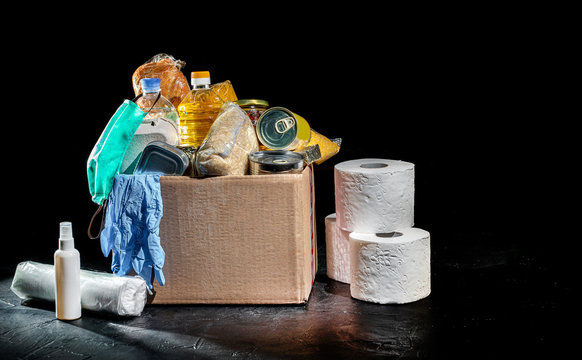 Donation box full of different products on dark background