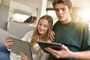 young couple connected on digital tablet at home