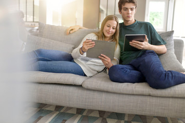 young couple connected on digital tablet at home