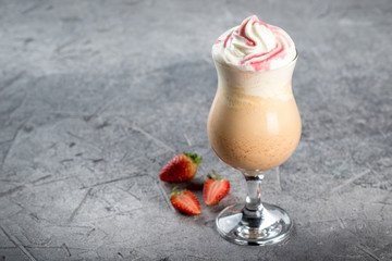 Strawberry milkshake in a glass on a leg