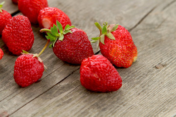Ripe juicy strawberries on a wooden background. Dessert. Vitamins