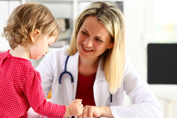 Fototapeta premium Little child with mother at pediatrician reception. Physical exam, cute infant portrait, baby aid, healthy lifestyle, ward round, child sickness, clinic test, high quality and trust concept