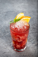 Berry cocktail with ice and orange slices