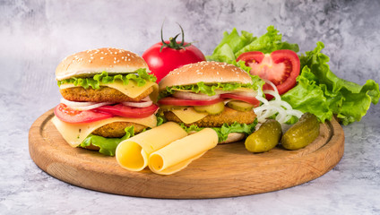 hamburgers on a wooden board on a gray background