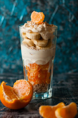 Concept of a healthy lifestyle and proper nutrition, healthy breakfast. Yogurt with banana, oatmeal and mandarin