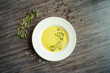 woman eating yellow vegetables cream soup