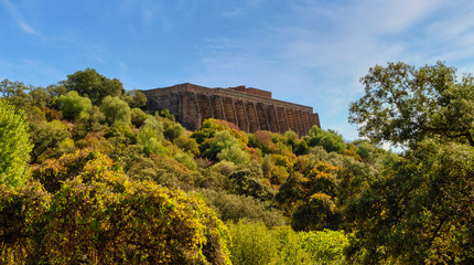 Archaeological site from the Roman era of Munigua or Mulva. Wall of the Sanctuary. Bright day.