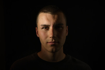 Fototapeta premium Dark and dramatic portrait of a serious and professional young man 