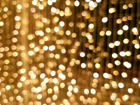 Defocused Image Of Illuminated Christmas Lights