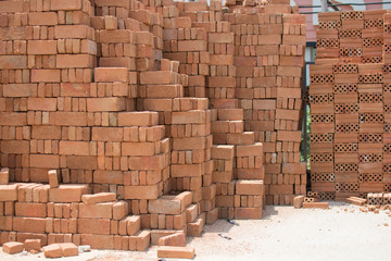 Many red bricks piles are used for wall cladding, construction wall