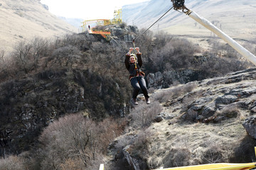 Woman riding on zip line