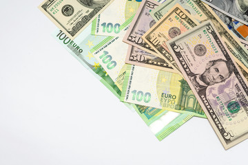 several dollars and euro notes on a white background