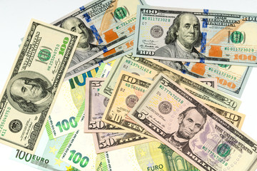 several dollars and euro notes on a white background