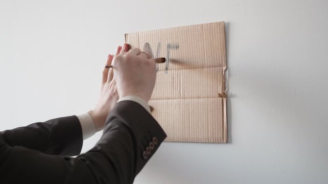 hands close-up write on a cardboard box ad looking for work. need job. covid-19
