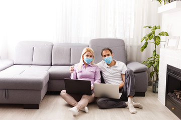 A young family works from home using computers. Couple working remotely online while on quarantine. Stay at home concept. Corona virus covid-19 pandemic outbreak. Freelance work