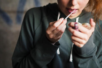 Obraz premium Girl is applying lip gloss. Make up