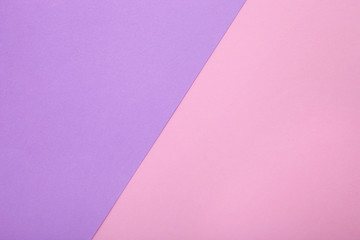 Pink and purple paper as background. Two colored pastel paper texture, top view with place for text