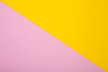 Pink and yellow paper as background. Two colored pastel paper texture, top view with place for text