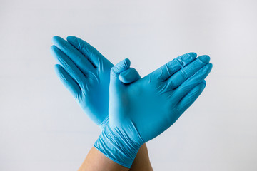 hand in medical glove, blue color, concept of protection against viruses