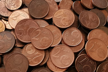 1, 2 and 5 euro cent coins texture background.  Selective focus.