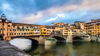 Fototapeta na wymiar The Ponte Vecchio and Vasari Corridor in Florence, Italy. Medieval stone closed-spandrel segmental arch bridge over the Arno River.