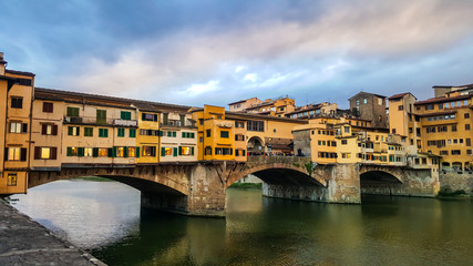 The Ponte Vecchio and Vasari Corridor in Florence, Italy. Medieval stone closed-spandrel segmental arch bridge over the Arno River.