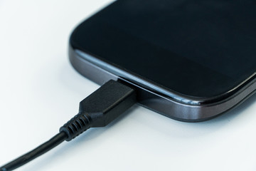 Smartphone charging with power bank on wood board