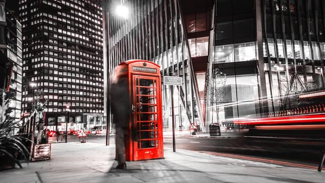Time lapse of British red phone box in busy London night street scene